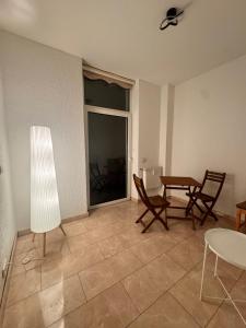 a living room with chairs and a table and a window at A&V Apartments Arena Schalke in Gelsenkirchen +6 photos