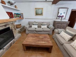 a living room with two couches and a fireplace at La Casa de Dori in Beteta