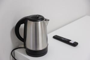 a tea kettle and a remote control on a counter at Ka Millordi in Frascineto