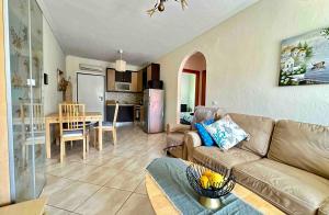 a living room with a couch and a table at Top Floor Apartments in Pefkochori