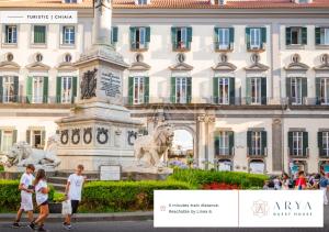 a group of people walking in front of a building at Arya Guest House in Naples