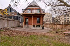 a house with a balcony on top of it at ENTIRE BACHELOR UNIT EN-SUITE ACROSS FROM GOOGLE - br2 in Kitchener