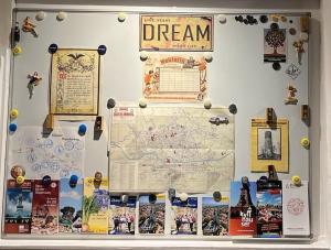a wall with a map and other items on it at Ferienwohnung 36, die etwas Andere in Quedlinburg +15 photos
