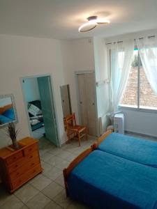 a bedroom with a bed and a dresser and a mirror at christiane cere in Amélie-les-Bains-Palalda