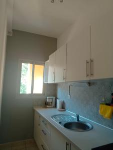 a kitchen with a sink and a window at christiane cere in Amélie-les-Bains-Palalda