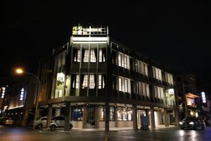 a building on a city street at night at Pinestone Inn in Jian