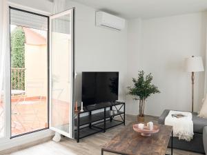 a living room with a large sliding glass door at ChillaHomes 103 in Candeleda