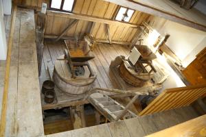 an overhead view of an old wooden building with buckets at Pensiunea Moara Lu Antone in Orăştioara de Sus