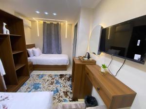 a hotel room with a bed and a television at Isis Pyramids View Inn in Cairo