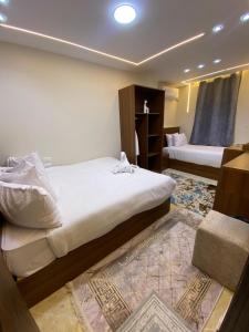 a bedroom with two beds and a rug at Isis Pyramids View Inn in Cairo