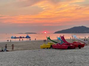 a group of boats on a beach at sunset at Hotel Miramar Playa America Nigran in Nigrán