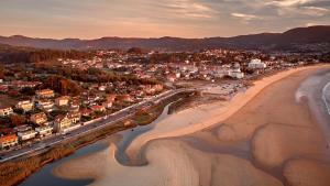 an aerial view of a beach with a city at Hotel Miramar Playa America Nigran in Nigrán