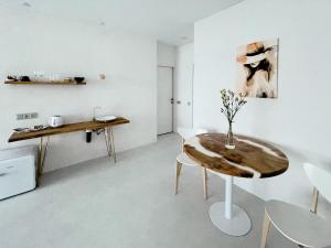 a white room with a wooden table and chairs at Studia-Focus-Design in Aktobe