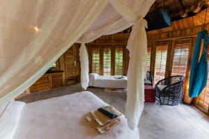 a bedroom with a bed and a canopy in a room at Hotel Las Islas in Barú +103 photos