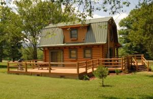 a log cabin with a large deck and a house at Smoky Mountains Blue Ridge Cabin Tennessee in Maryville