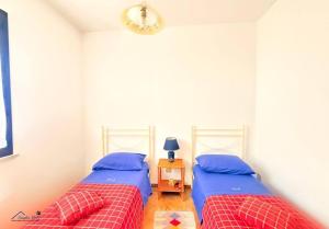two twin beds in a bedroom with a table at Residenza Marechiaro in Paparella