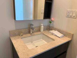 a bathroom counter with a sink and a mirror at Comfort in Richmond center 2bedr & good location in Richmond +21 photos