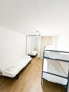 a room with two bunk beds and a mirror at Ibiza Port Rooms in Ibiza Town