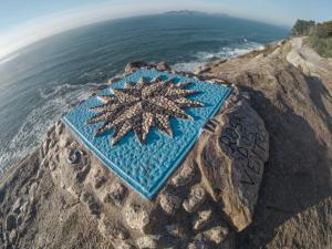 a star on the side of a rock near the ocean at Hotel Miramar Playa America Nigran in Nigrán