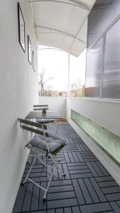 a room with a table and chairs on a tiled floor at LIMIDI HOMES --- Spacious Two-Bedroom Apartment in City Centre --- Ideal Location for Exploring Veliko Tarnovo in Veliko Tŭrnovo +63 photos