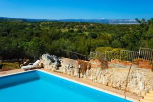 a villa with a swimming pool with a view at Fattoria Terra e Libertà in Contrada Maeggio