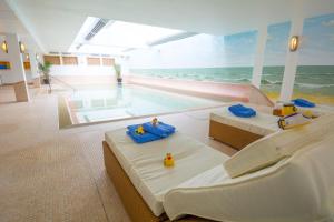 a hotel room with two beds and a swimming pool at Hotel Atlantic Juist in Juist