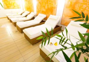 a row of white chairs in a waiting room at Hotel Atlantic Juist in Juist