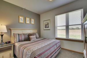 a bedroom with a large bed and a window at Nauvoo Vacation Condos and Villas in Nauvoo