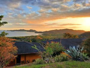a view of a house with a lake in the background at Eco Boutique Hotel Vista Las Islas Reserva Natural in Paquera +55 photos