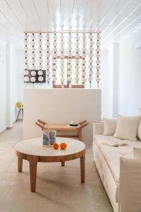 a living room with a couch and a coffee table at Angelina Boutique Escape in Perdika
