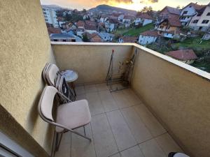 a balcony with a chair and a table and a view at Relje krilatice in Novi Pazar