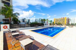 a swimming pool on the roof of a building at Ozped Private Flats Comfort Suites in Brasília