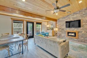 a living room with a couch and a fireplace at Modern and Cozy 5BR Family Cabin with Private Pool, Hot Tub, Pool Table, Fire Pit & Cozy Mountain Vibes in Sevierville