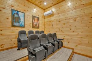 a conference room with chairs in a wooden wall at Modern and Cozy 5BR Family Cabin with Private Pool, Hot Tub, Pool Table, Fire Pit & Cozy Mountain Vibes in Sevierville
