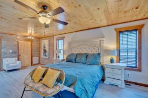 a bedroom with a bed and a ceiling fan at Modern and Cozy 5BR Family Cabin with Private Pool, Hot Tub, Pool Table, Fire Pit & Cozy Mountain Vibes in Sevierville