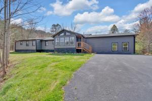 a large home with a large driveway in front of it at Modern and Cozy 5BR Family Cabin with Private Pool, Hot Tub, Pool Table, Fire Pit & Cozy Mountain Vibes in Sevierville