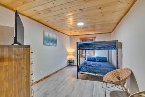 a bedroom with a bunk bed and a wooden ceiling at Modern and Cozy 5BR Family Cabin with Private Pool, Hot Tub, Pool Table, Fire Pit & Cozy Mountain Vibes in Sevierville