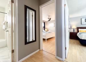 a hallway with a mirror and a bedroom at Sea View Escape Unit #2 in San Clemente