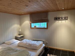 a bedroom with two beds and a window at Large and beautiful cabin in Løfald