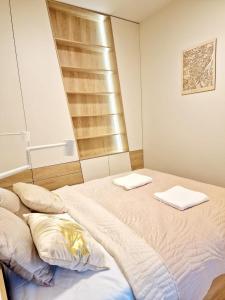 a bedroom with a bed with two towels on it at Hanza Tower 615 in Szczecin
