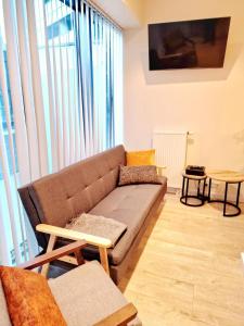 a living room with a couch and a large window at Hanza Tower 615 in Szczecin +5 photos