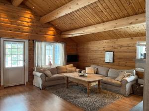 a living room with a couch and a table at Large and beautiful cabin in Løfald