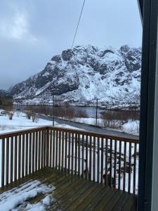 a balcony with a view of a snow covered mountain at House in Vågan in Hopen