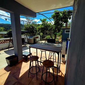 a table and two stools sitting on a patio at Casa Rural El Bressol in Barraca de Aguas Vivas