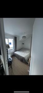 a bedroom with a bed and a window at Appartement bord de mer in Jullouville-les-Pins