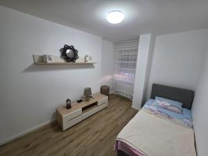 a bedroom with a bed and a dresser in it at Varosmala in Novi Pazar +7 photos