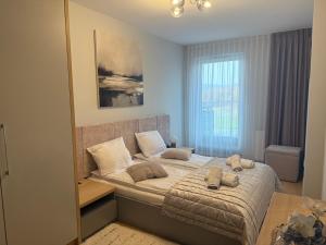 a bedroom with a bed with two stuffed animals on it at Apartament Księżycowy z garażem in Nowy Sącz