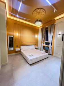a bedroom with a large white bed and a chandelier at Mia House Prestige in Rome