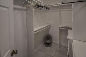a walk in closet with a toilet in a room at Sunny Family Home in Denver with huge yard and hot tub in Denver +61 photos