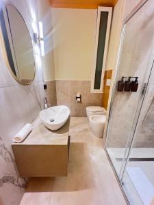 a bathroom with a sink and a shower and a toilet at Mia House Prestige in Rome